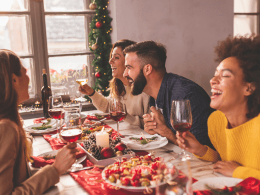 Woman smiling while enjoying Christmas dinner – managing Christmas food anxiety.